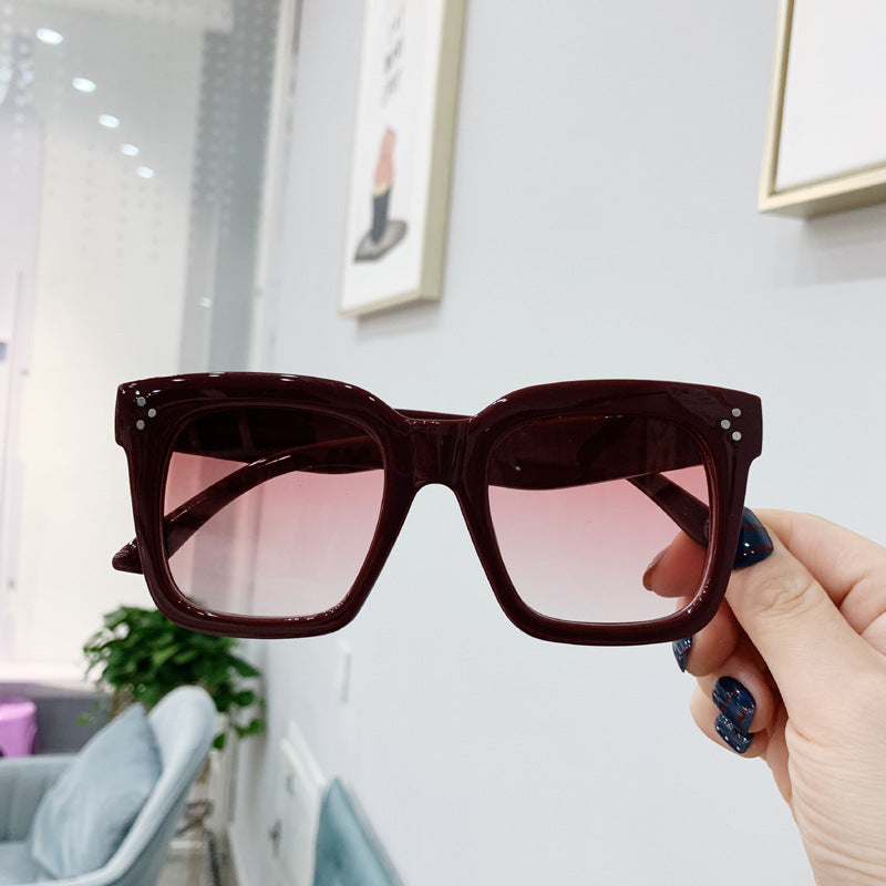 Retro square UV400 sunglasses by RAMODO JEWELRY with dark tinted lenses and thick black frames.