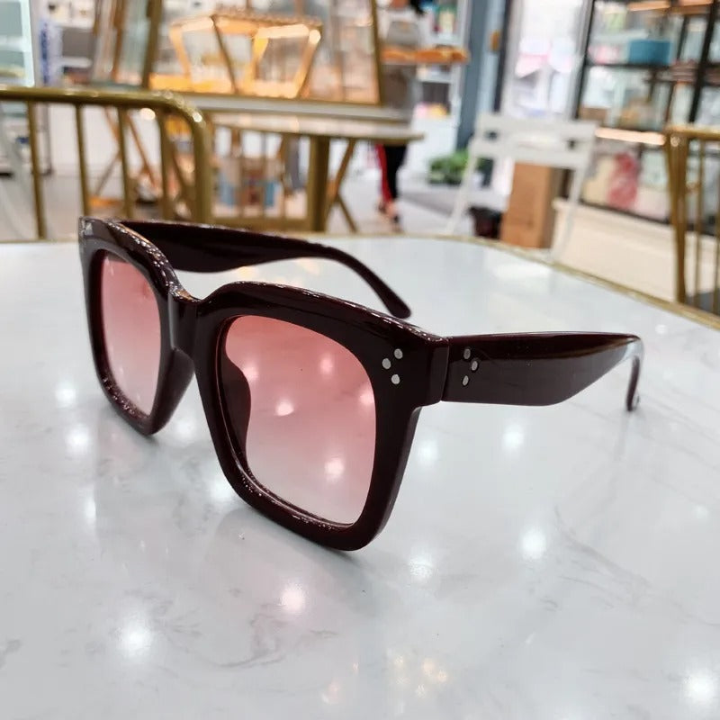 Retro square UV400 sunglasses by RAMODO JEWELRY with black frames and tinted lenses, stylish eyewear for sun protection.