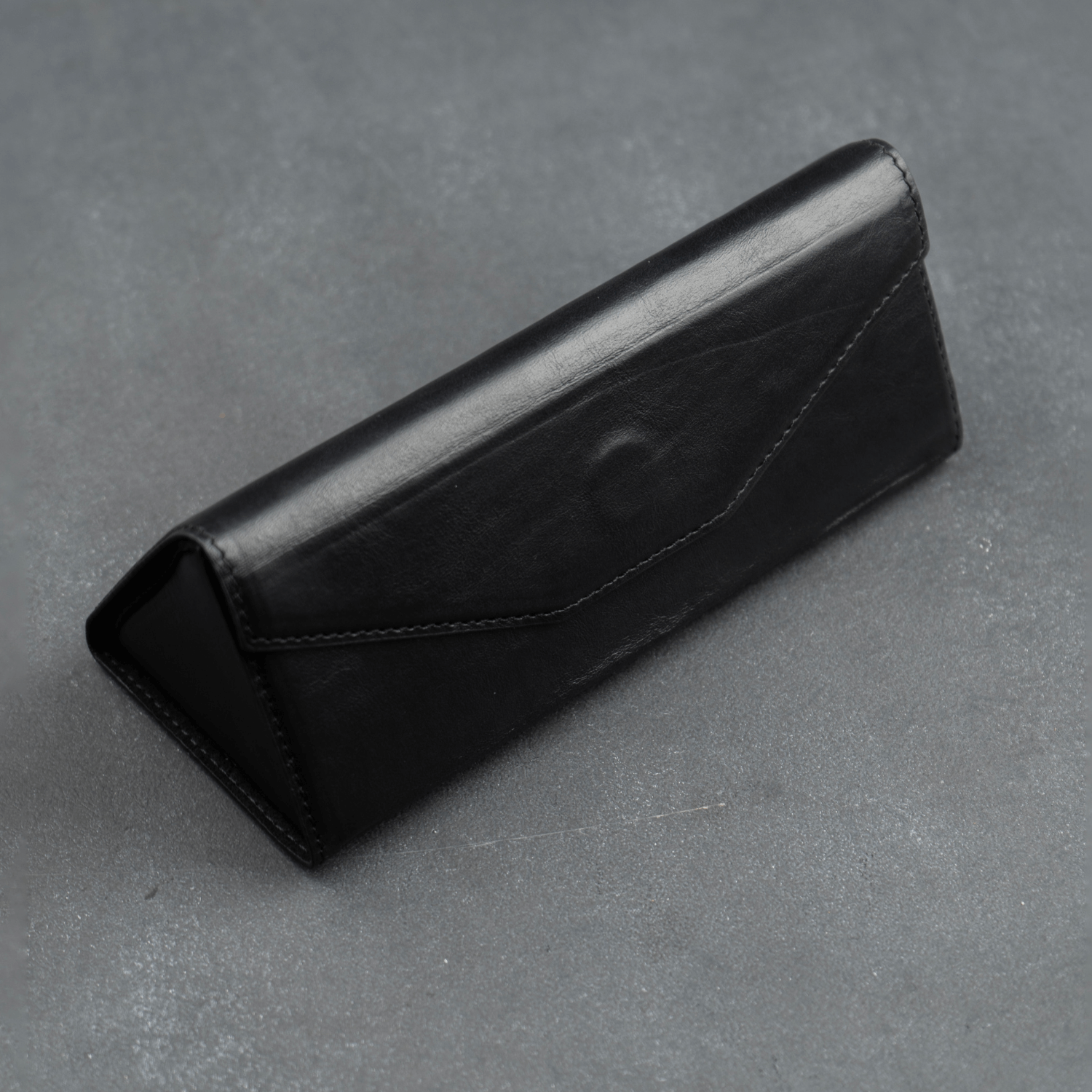 Black luxury leather sunglasses case by LEATHERE, designed for eyewear accessories, with a sleek and stylish appearance.