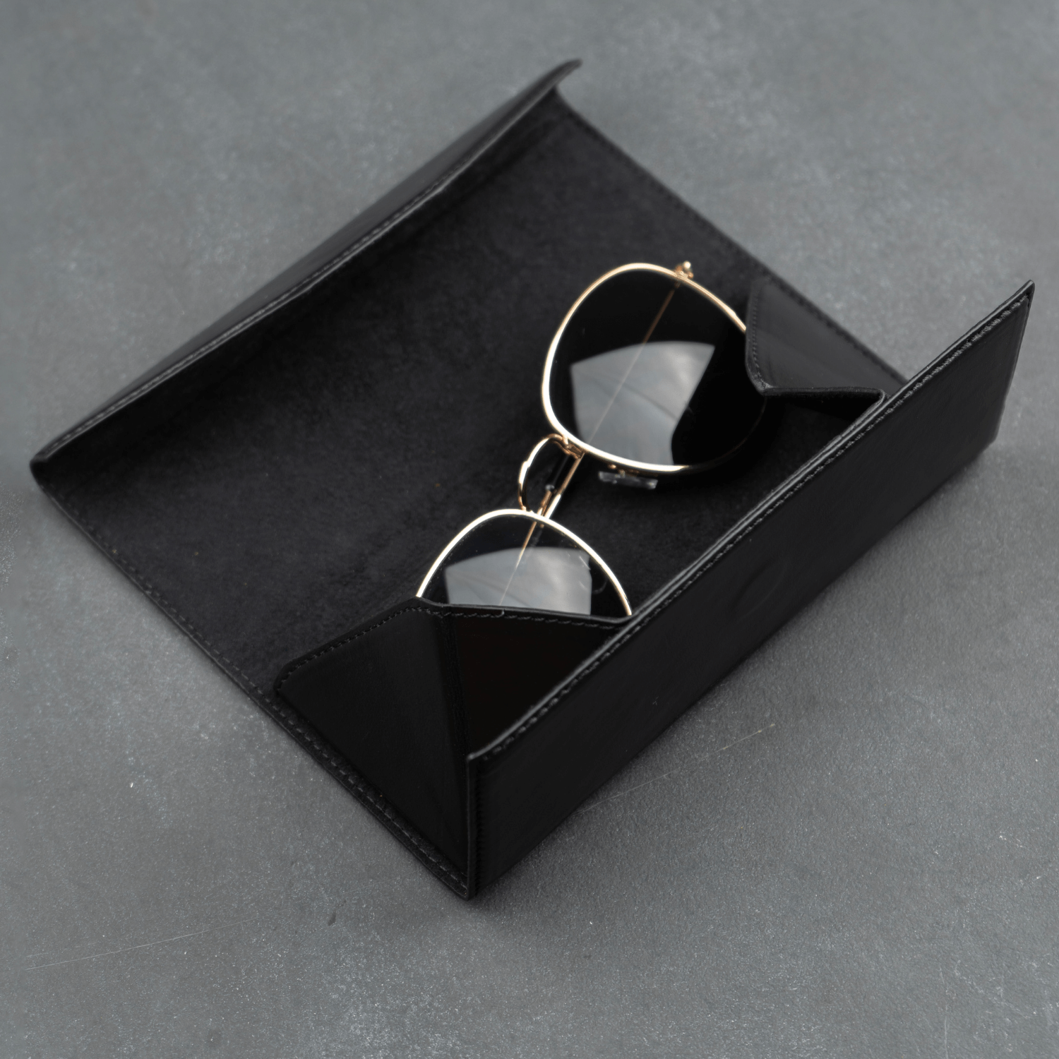 Black luxury leather sunglasses case by LEATHERE, designed as an elegant eyewear accessory for protecting sunglasses.