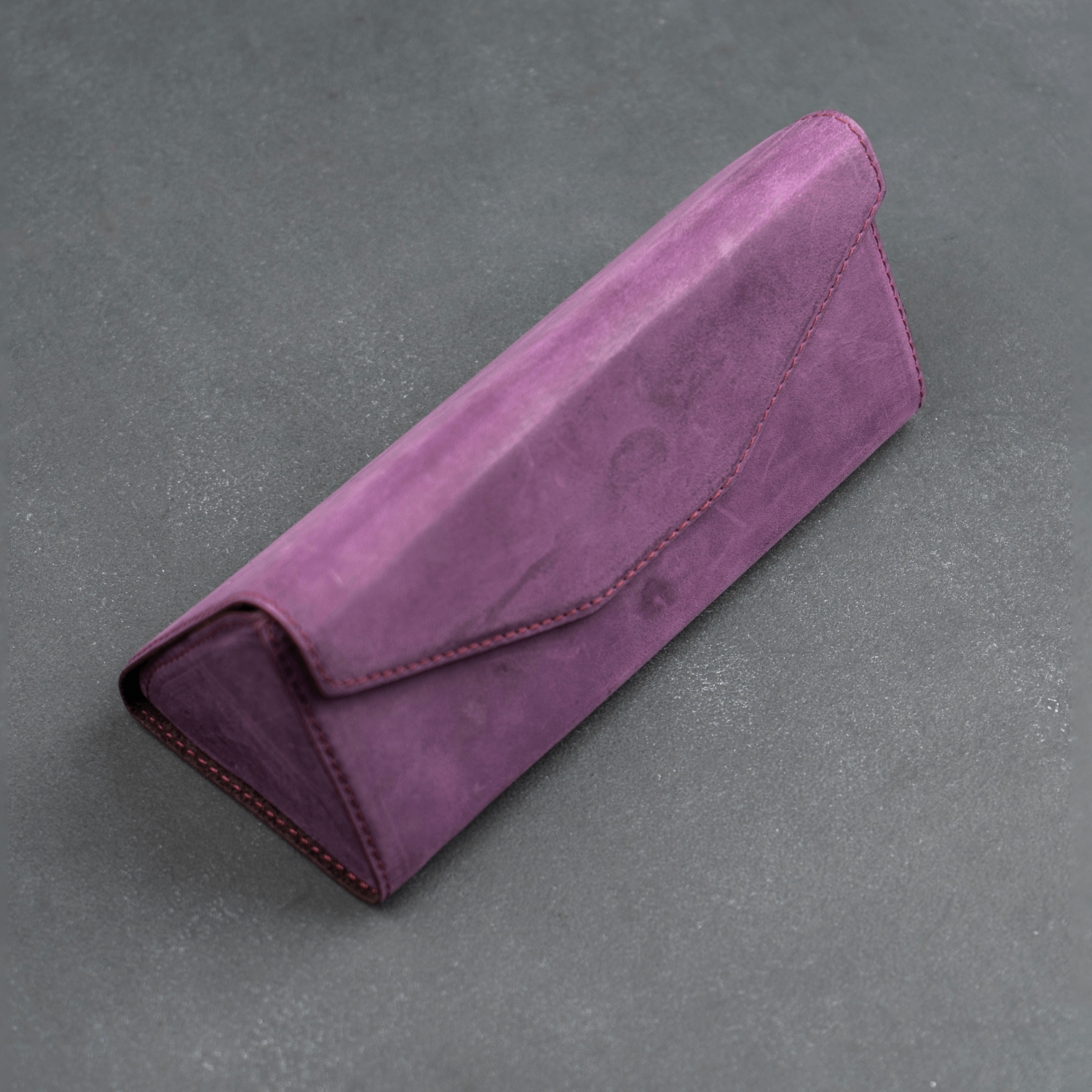 Purple leather sunglasses case by LEATHERE, a stylish eyewear accessory with a soft interior for protection.