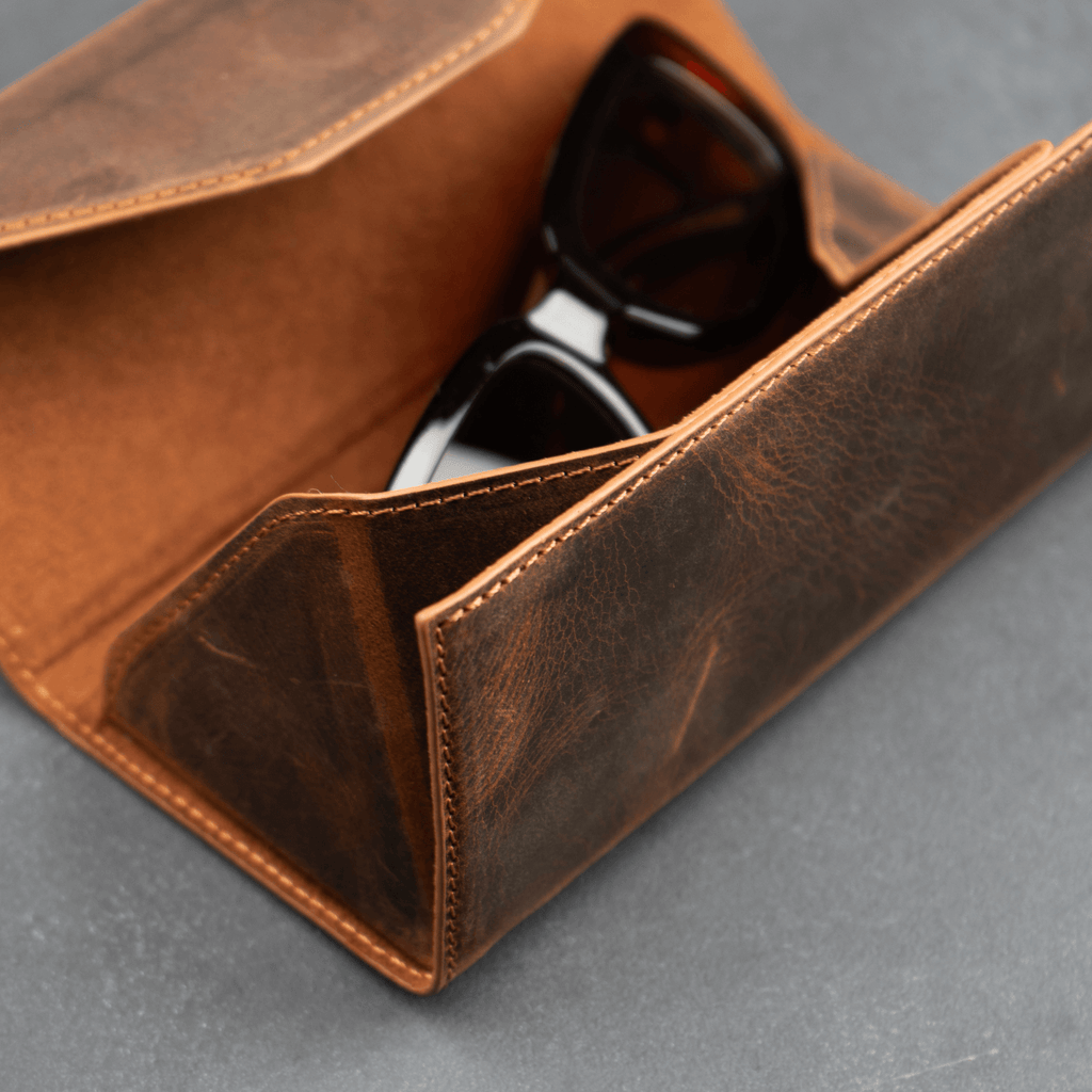 Dark brown luxury leather sunglasses case by LEATHERE, designed as an elegant eyewear accessory with a sleek finish.