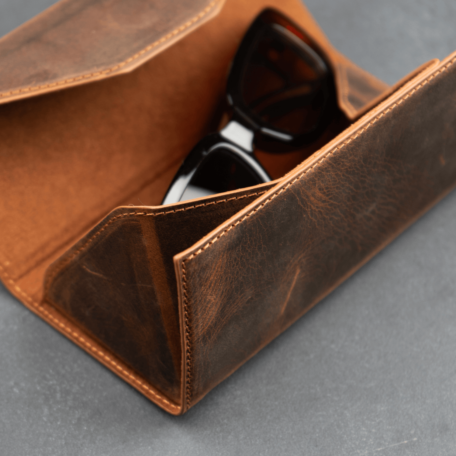 Dark brown luxury leather sunglasses case by LEATHERE, designed as an elegant eyewear accessory with a sleek finish.