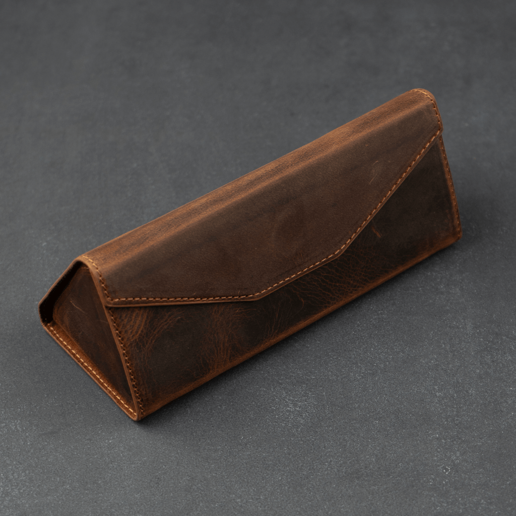 Dark brown luxury leather sunglasses case by LEATHERE, stylish eyewear accessory for protecting and storing sunglasses.