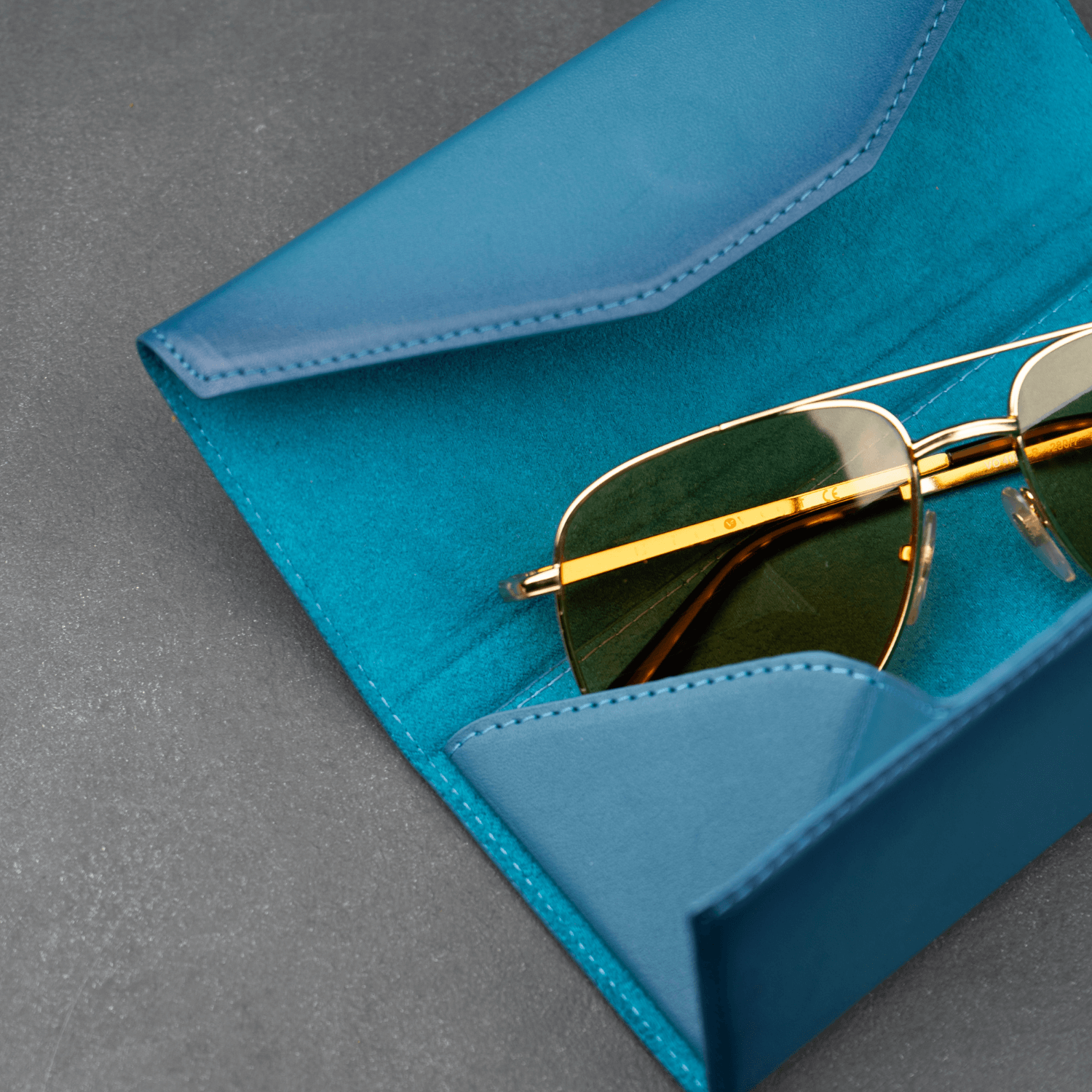 Dark blue luxury leather sunglasses case by LEATHERE, stylish eyewear accessory with soft interior for protection.