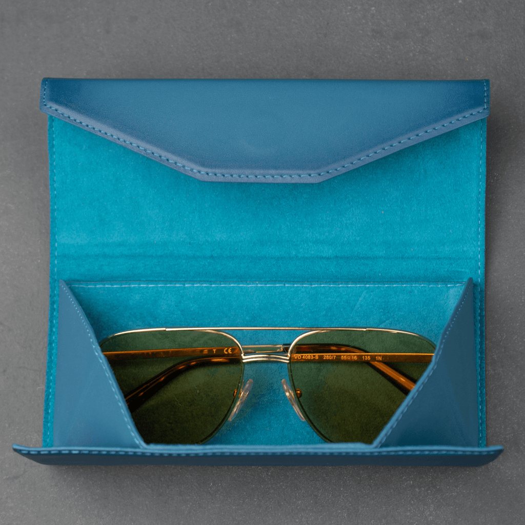 Dark blue LEATHERE luxury leather sunglasses case for eyewear accessories, featuring a sleek, stylish design.