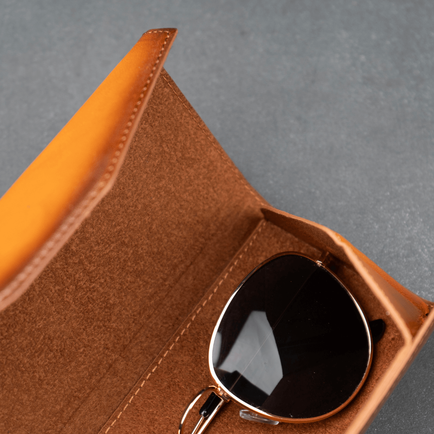 Rustic brown LEATHERE luxury leather sunglasses case for eyewear accessories, featuring a sleek, protective design.