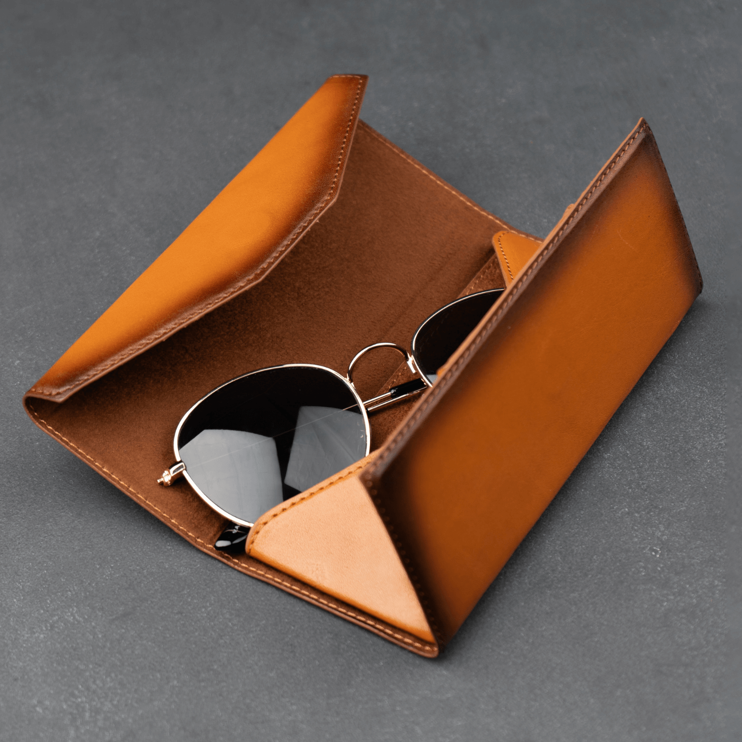 Rustic brown LEATHERE luxury leather sunglasses case for eyewear accessories, featuring a sleek, protective design.