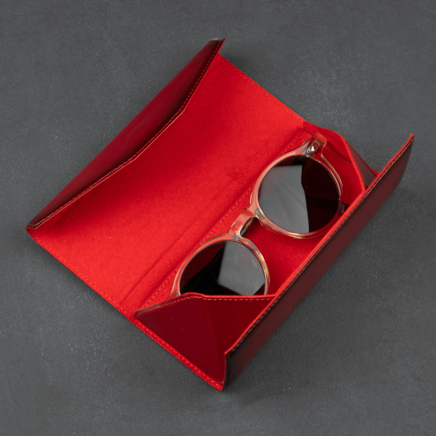Red luxury leather sunglasses case by LEATHERE, stylish eyewear accessory with a premium leather finish.