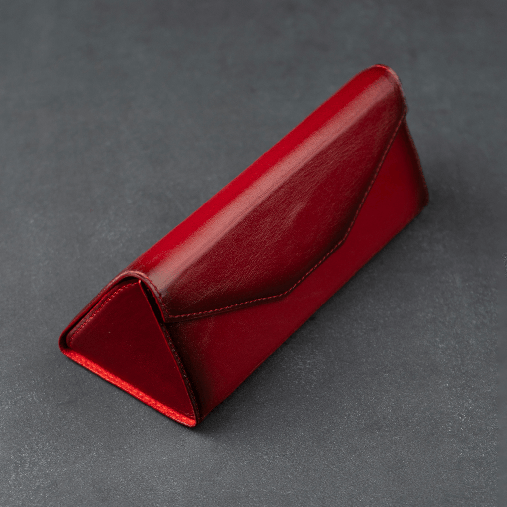 Red luxury leather sunglasses case by LEATHERE, designed for eyewear accessories, with a sleek and stylish appearance.