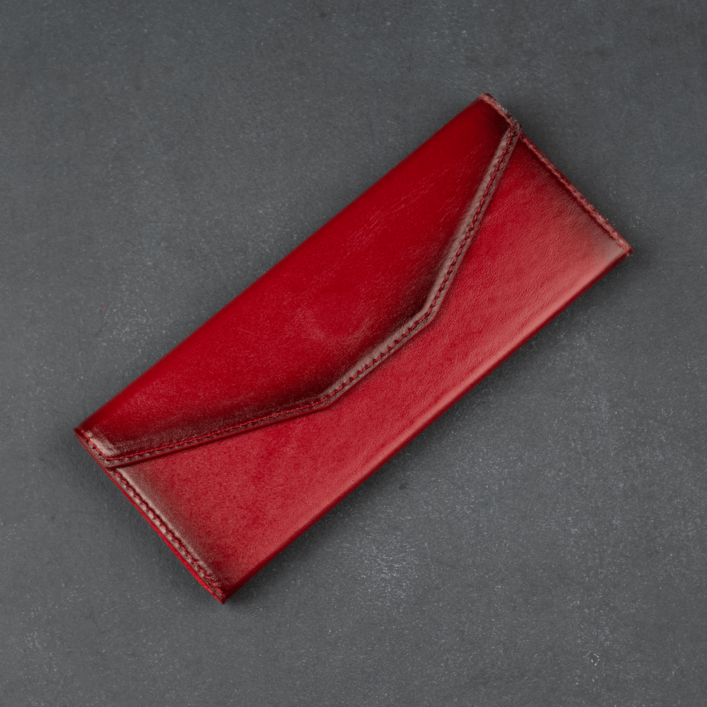 Red luxury leather sunglasses case by LEATHERE, stylish eyewear accessory for protecting and storing sunglasses.
