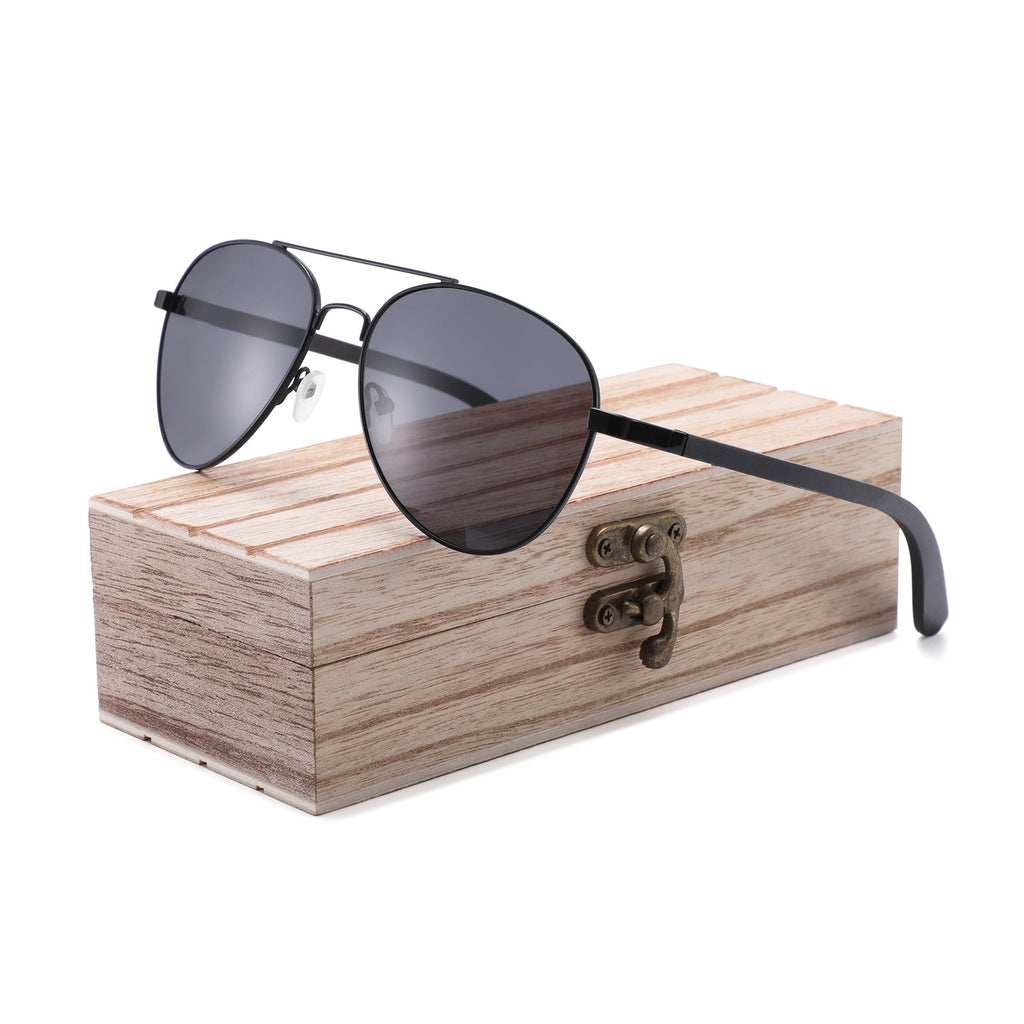 Handmade Papago Ebony Wood Palomas sunglasses with sleek wooden frames and dark tinted lenses, showcasing natural wood grain.