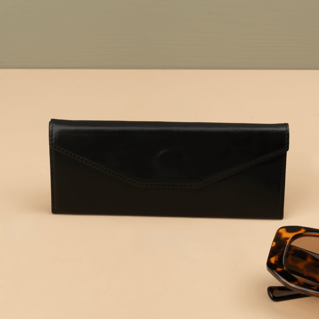 Black LEATHERE luxury leather sunglasses case for eyewear accessories, showcasing a sleek, protective design with subtle branding.