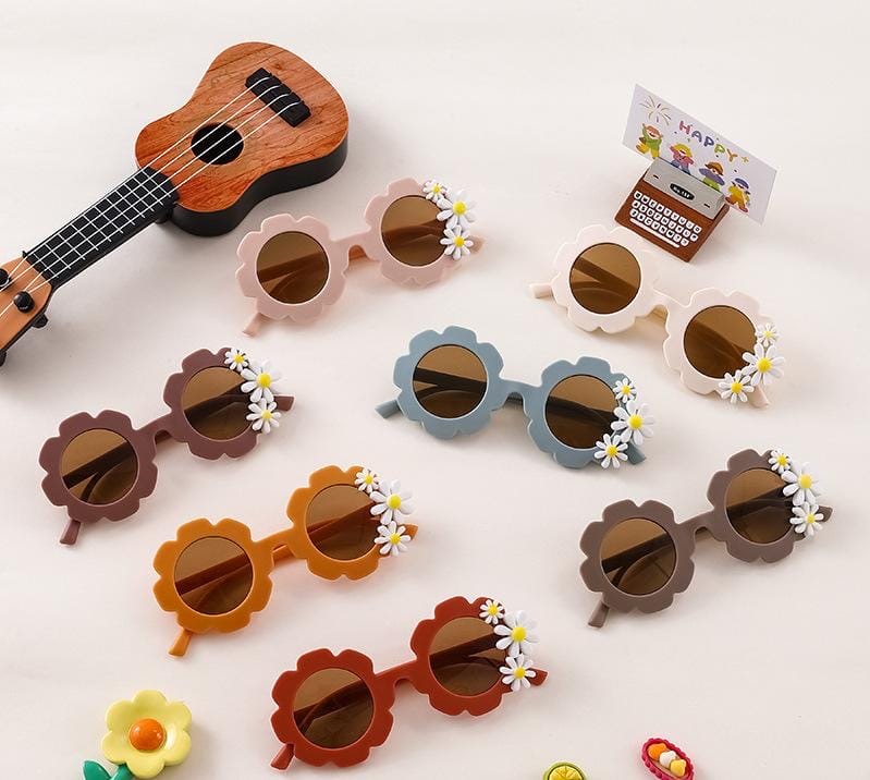 Kids' retro flower-shaped sunglasses with daisy design from ozznekshoes, featuring colorful frames and playful floral details.