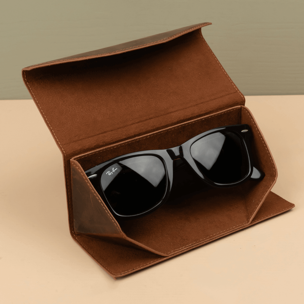 Dark brown luxury leather sunglasses case by LEATHERE, stylish eyewear accessory with secure closure and elegant design.