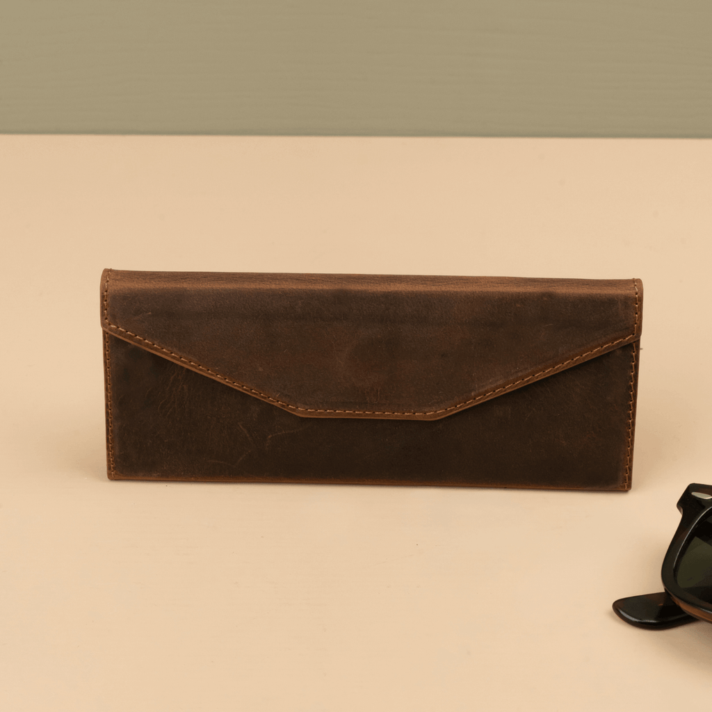 Dark brown luxury leather sunglasses case by LEATHERE, stylish eyewear accessory with a sleek, protective design.