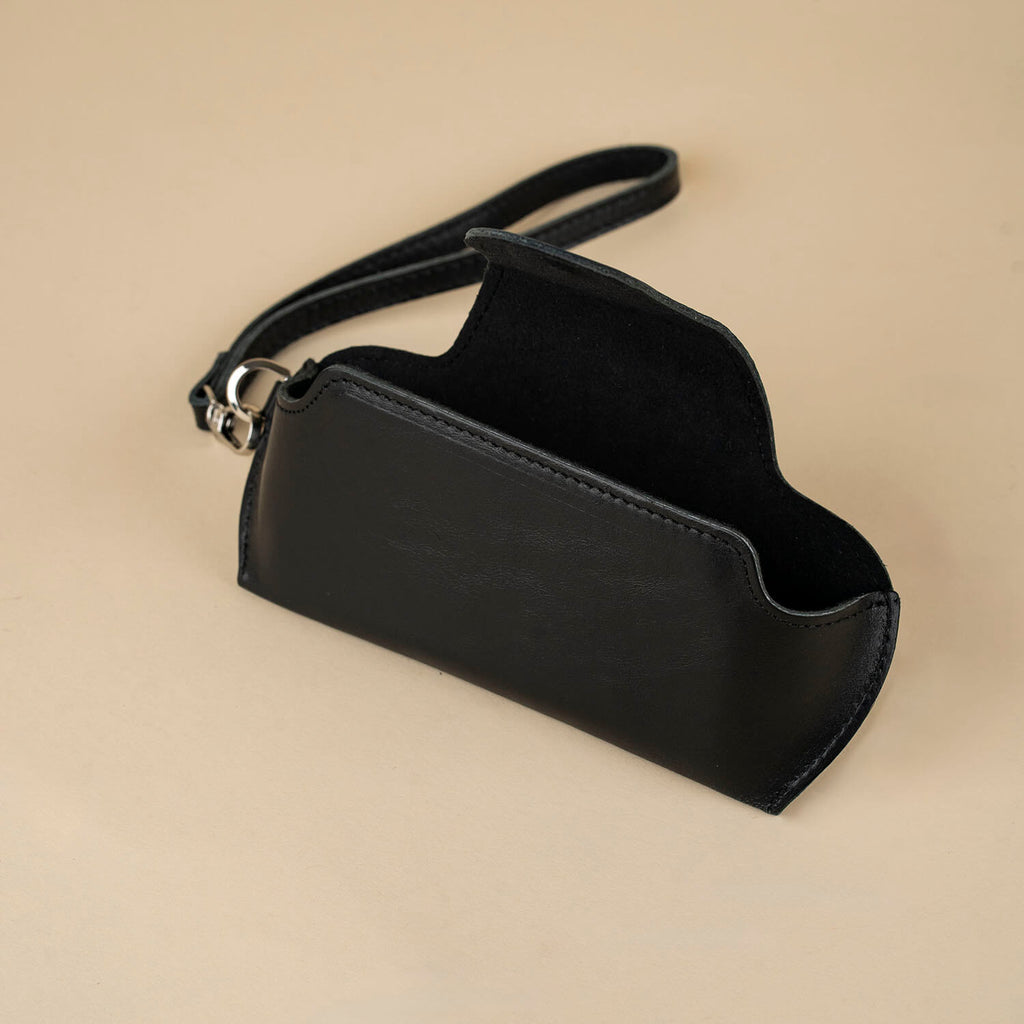 Black leather sunglass case with wrist strap by LEATHERE, designed for eyewear protection and convenience.