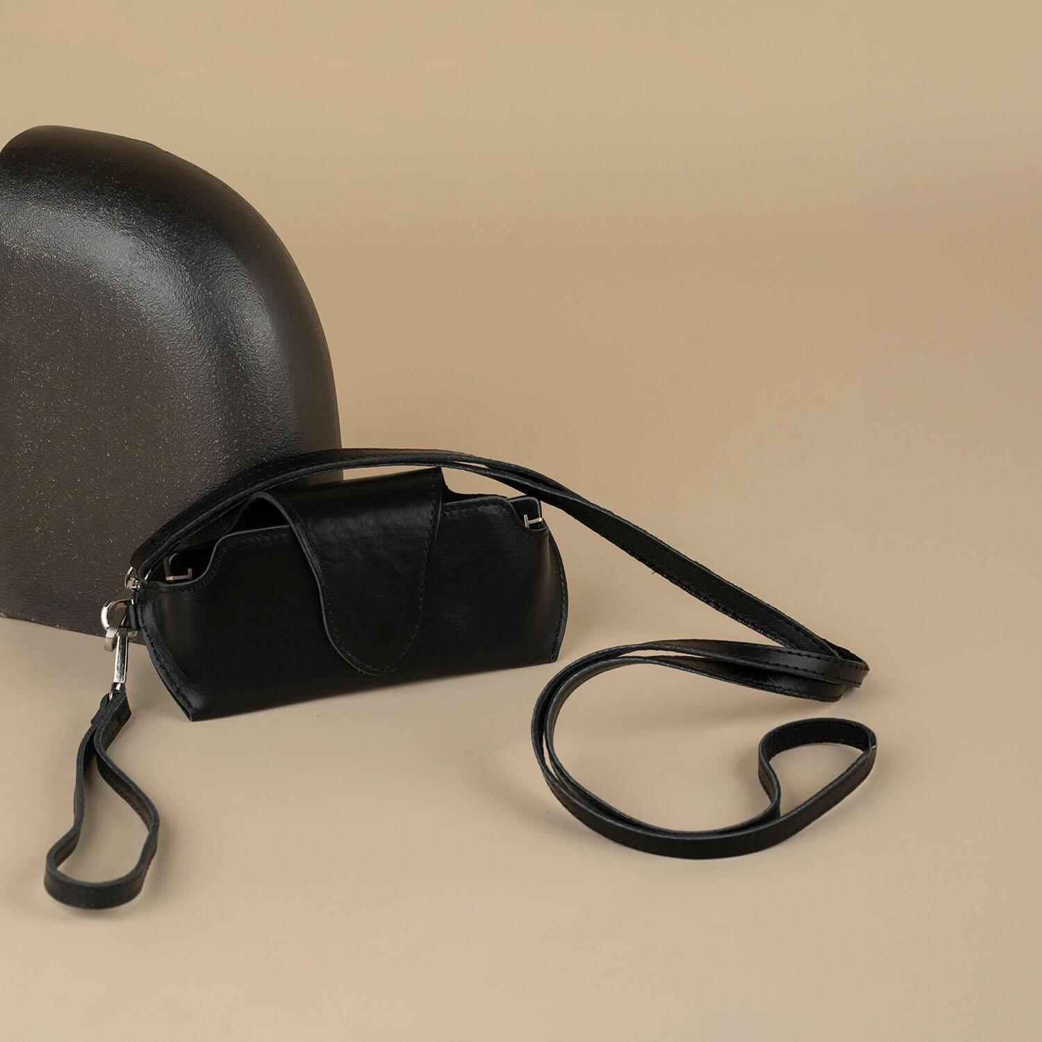 Black leather sunglass case with wrist strap by LEATHERE, designed for eyewear protection and easy carrying.
