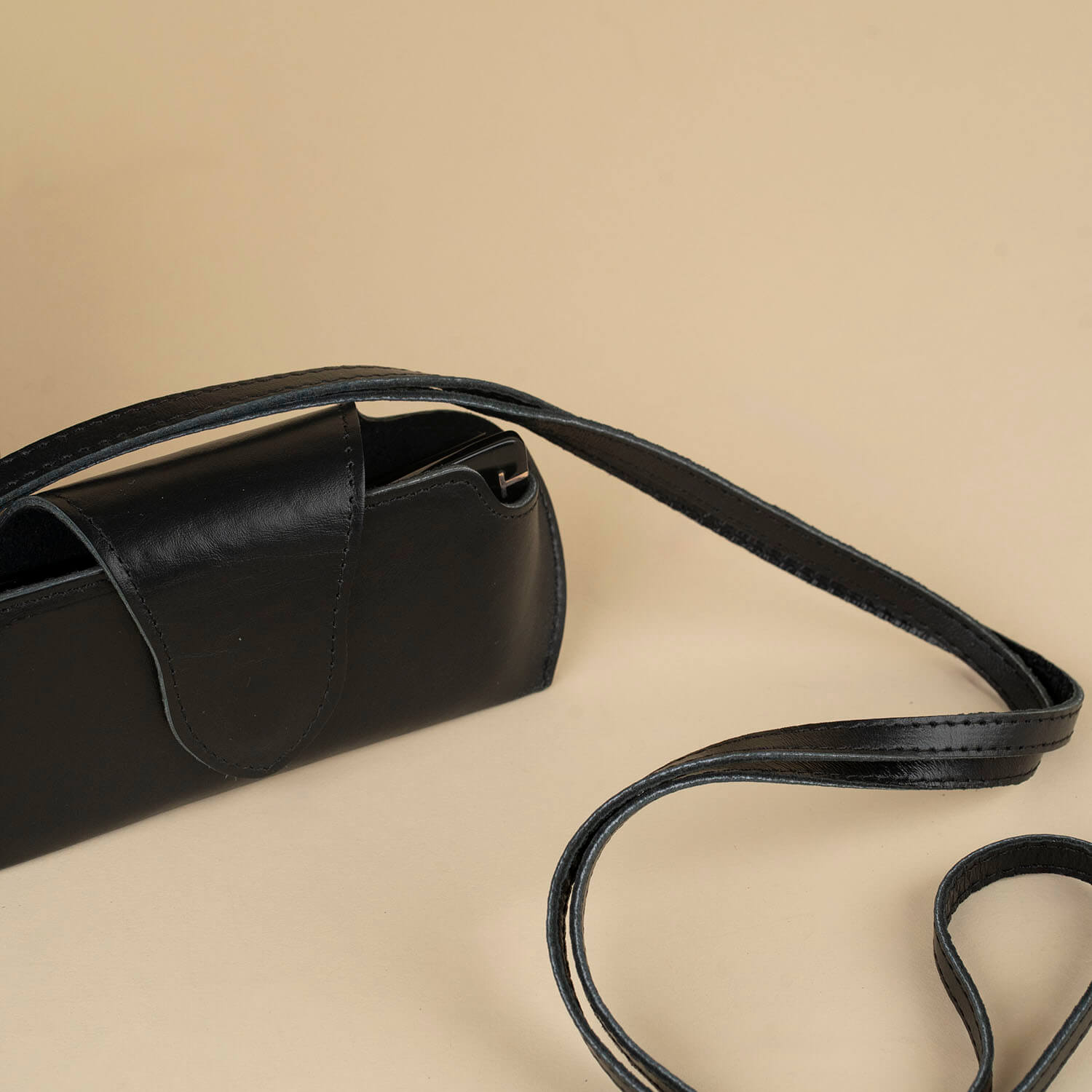 Black leather sunglass case with wrist strap by LEATHERE, designed for eyewear protection and easy carrying.