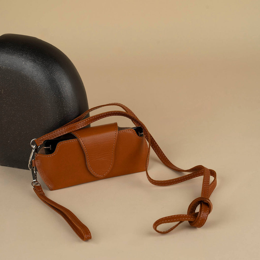 Medium brown leather sunglass case with wrist strap from LEATHERE, designed for eyewear protection and easy carrying.