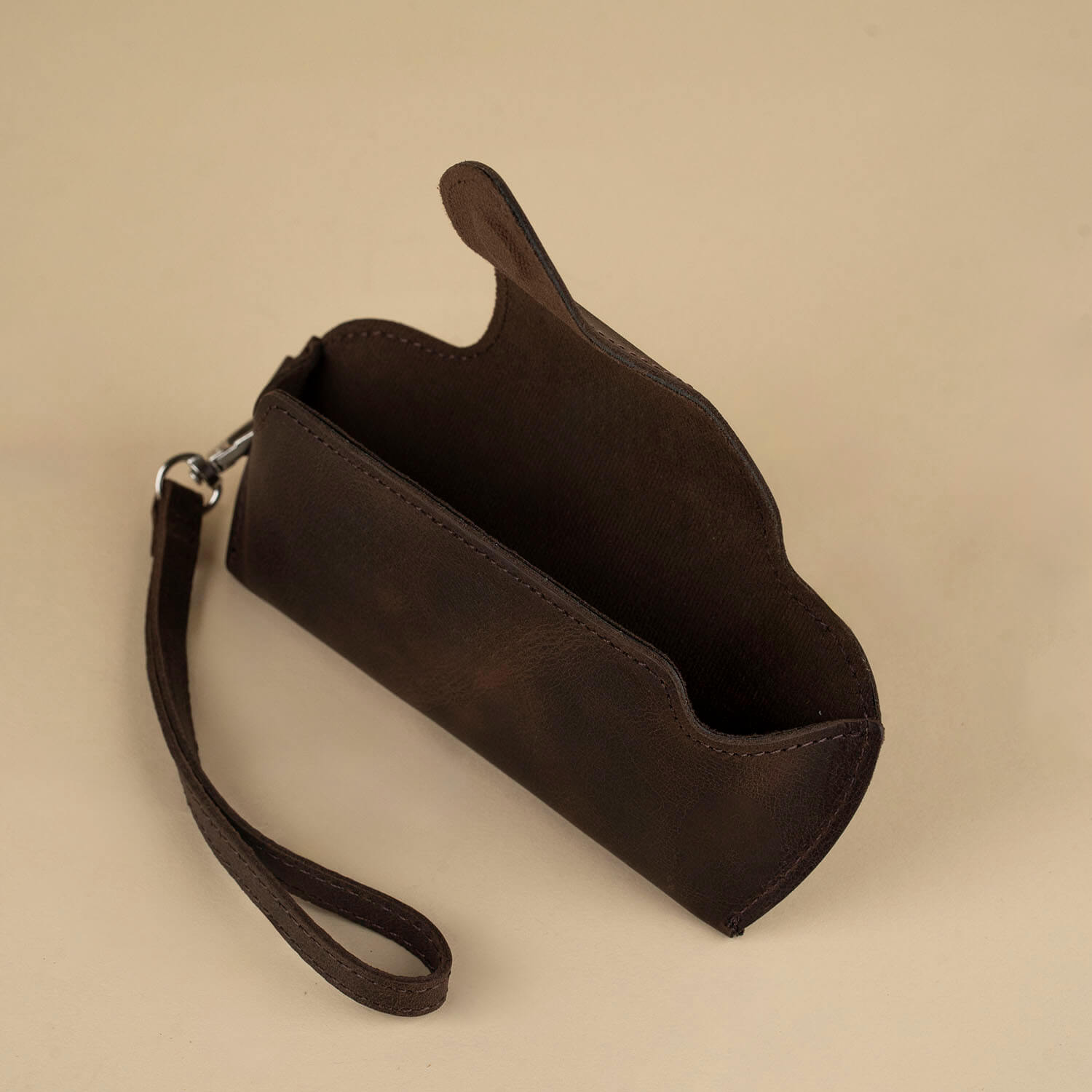 Dark brown leather sunglass case with wrist strap by LEATHERE, designed for eyewear accessories and stylish protection.