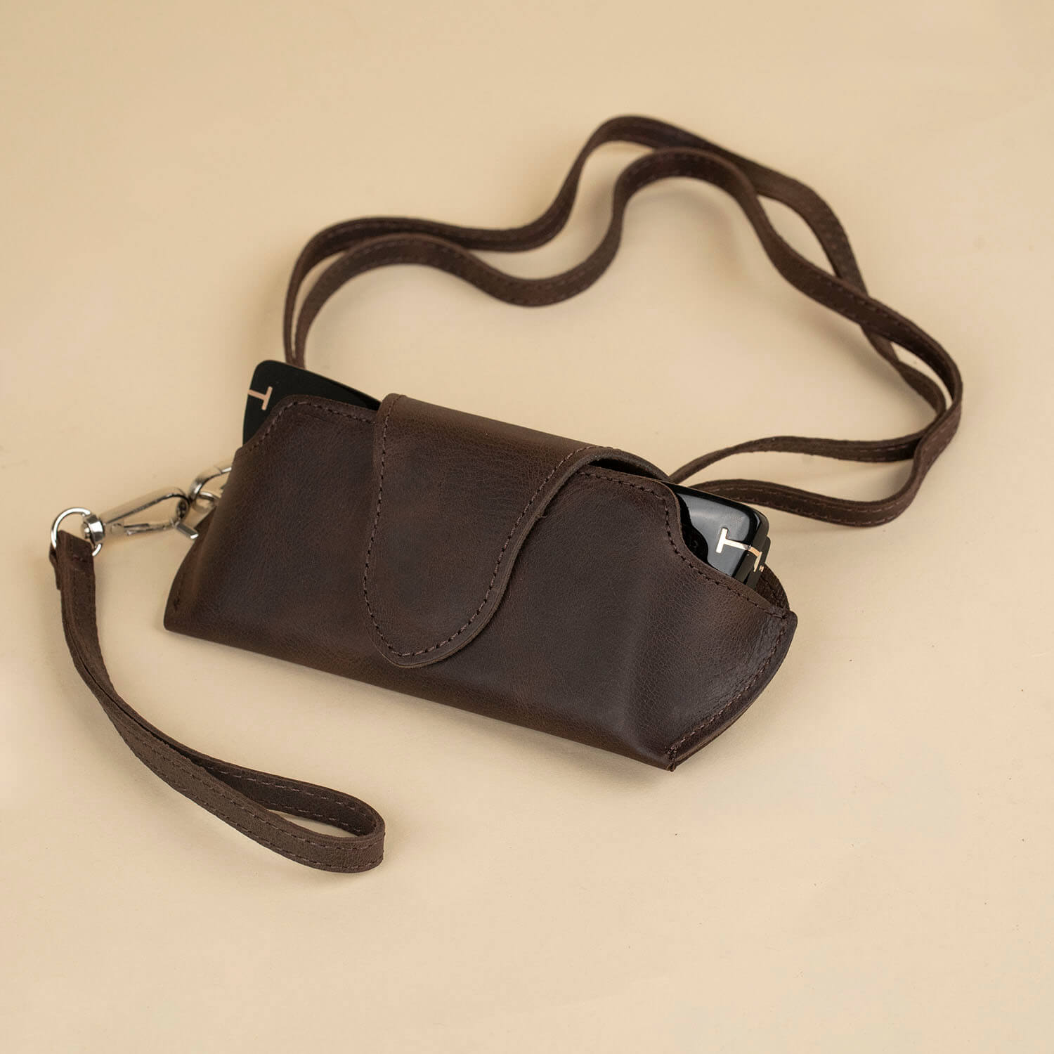 Dark brown leather sunglass case with a wrist strap by LEATHERE, designed for eyeglasses or sunglasses protection.