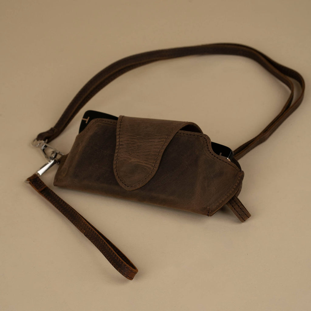 Rich dark brown leather sunglass case with wrist strap by LEATHERE, designed for eyewear accessories and stylish protection.