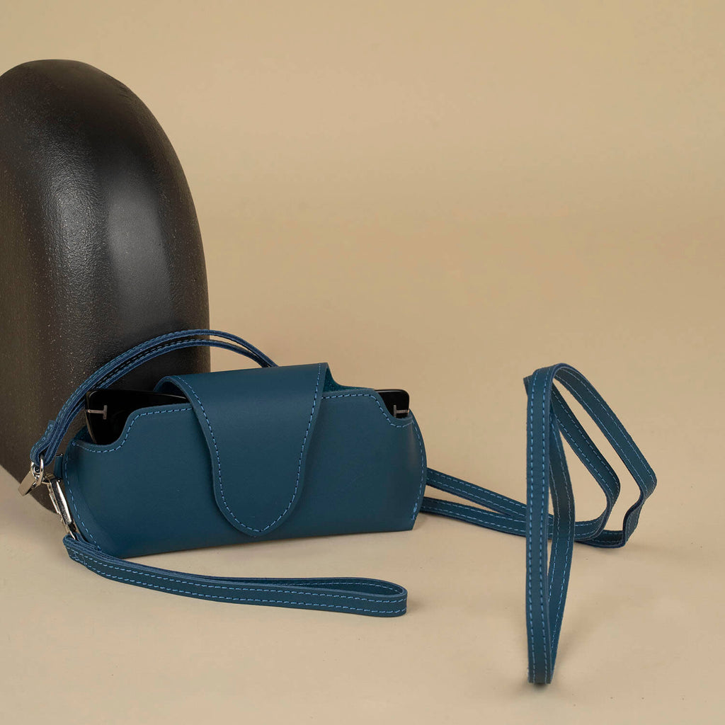 Navy blue leather sunglass case with wrist strap by LEATHERE, designed for eyewear accessories, shown on a plain background.