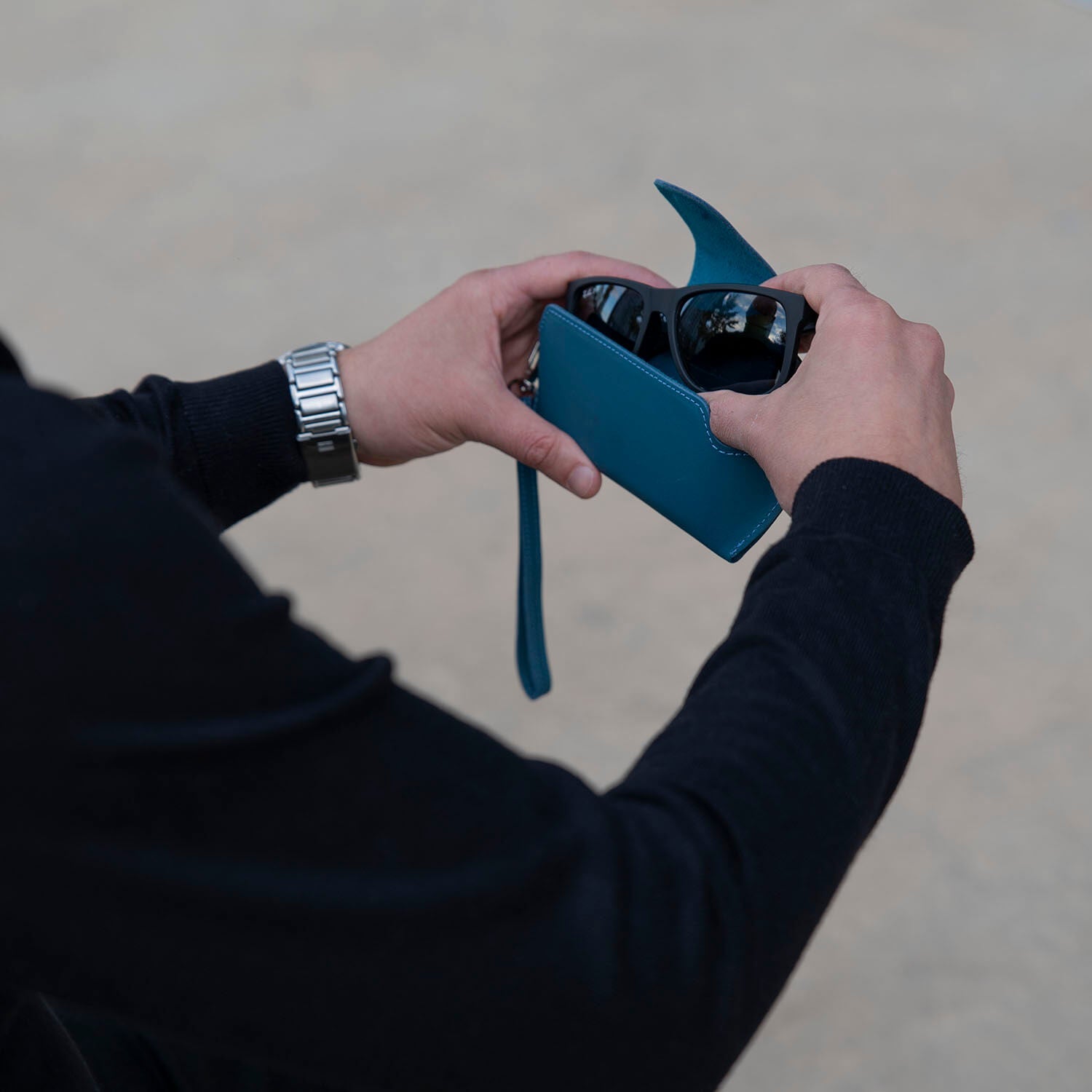 Navy blue leather sunglass case with wrist strap by LEATHERE, designed for eyewear protection and easy carrying.