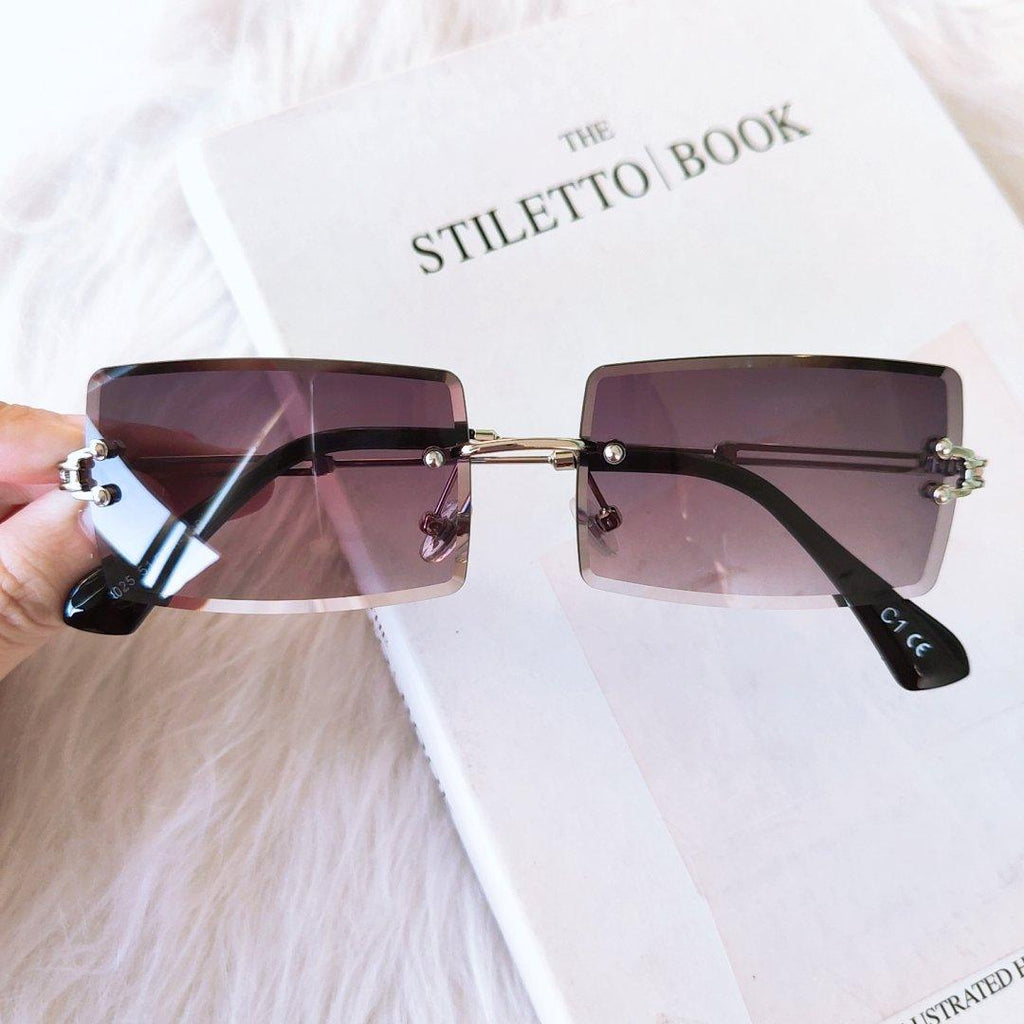 Stevvex fashion rimless rectangle UV400 sunglasses with dark lenses and slim metal arms on a neutral background.