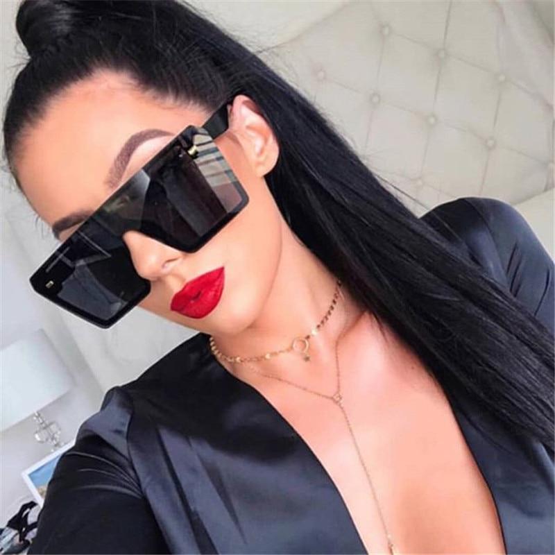 Modern oversized square UV400 sunglasses by Stevvex with black frames and dark tinted lenses on a white background