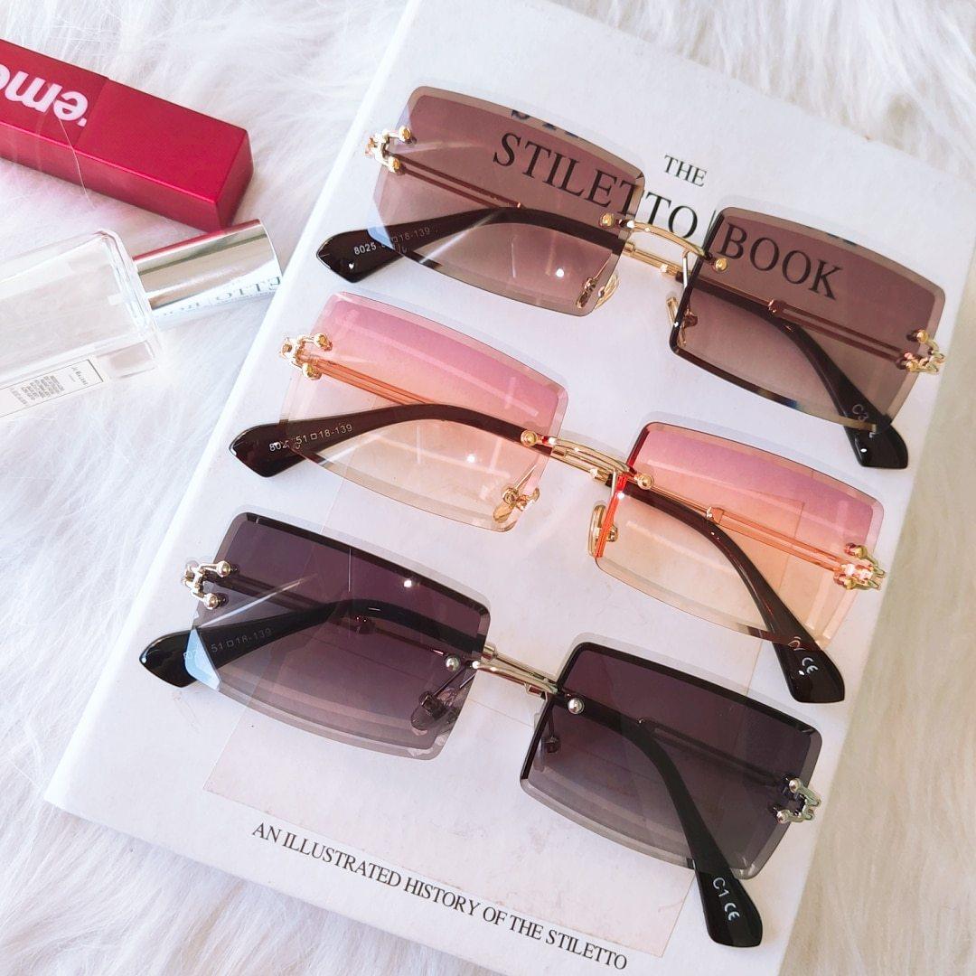 Stevvex fashion rimless rectangle UV400 sunglasses with clear lenses and sleek black frames, stylish and protective eyewear.
