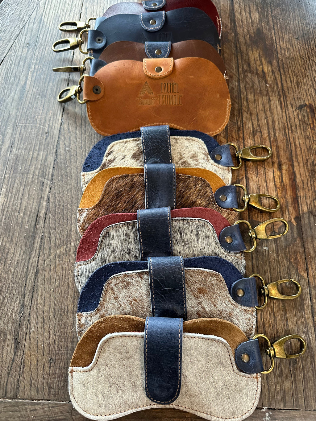 IXCHELTRIANGLE hair on hide sunglass case, stylish eyewear accessory with textured leather exterior and secure closure.