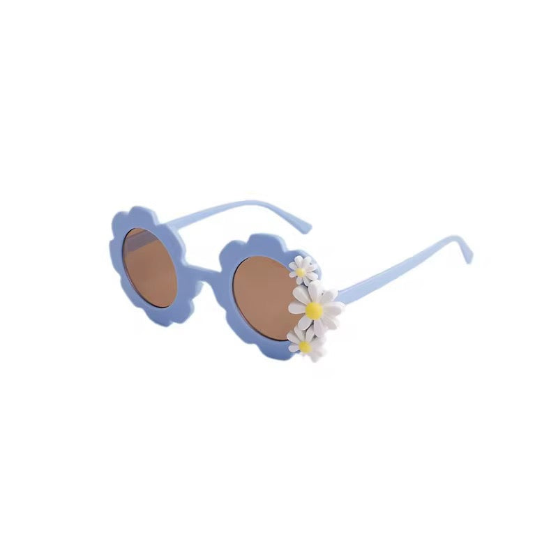 Kids retro flower-shaped sunglasses by ozznekshoes with colorful petal frames and dark tinted lenses.