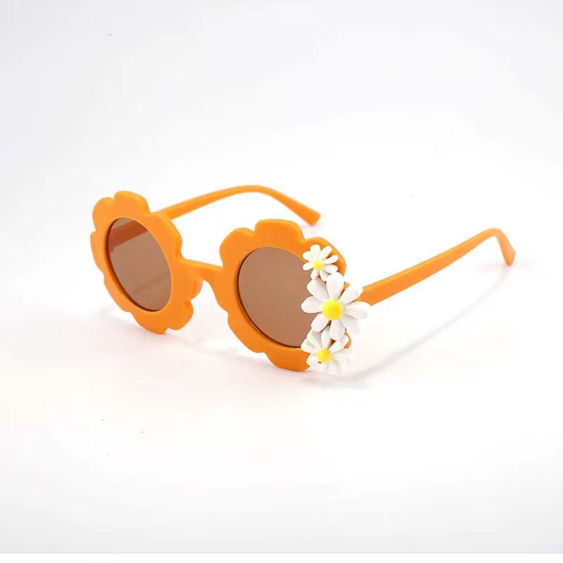 Kids' retro flower-shaped sunglasses by ozznekshoes with colorful daisy bloom design, perfect for playful summer style.