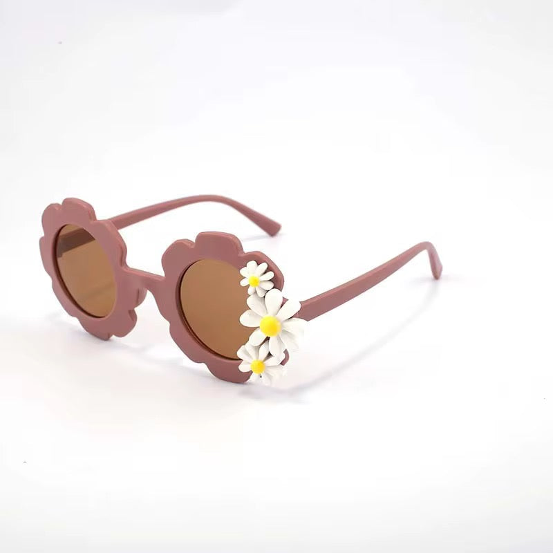 Kids' retro flower-shaped sunglasses by Ozznekshoes with colorful daisy bloom design, perfect for playful summer style.