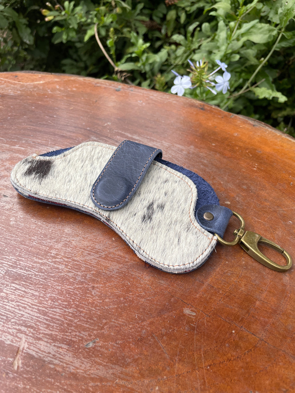 Leather sunglass case with hair-on-hide design from IXCHELTRIANGLE, showcasing a stylish and protective eyewear accessory.