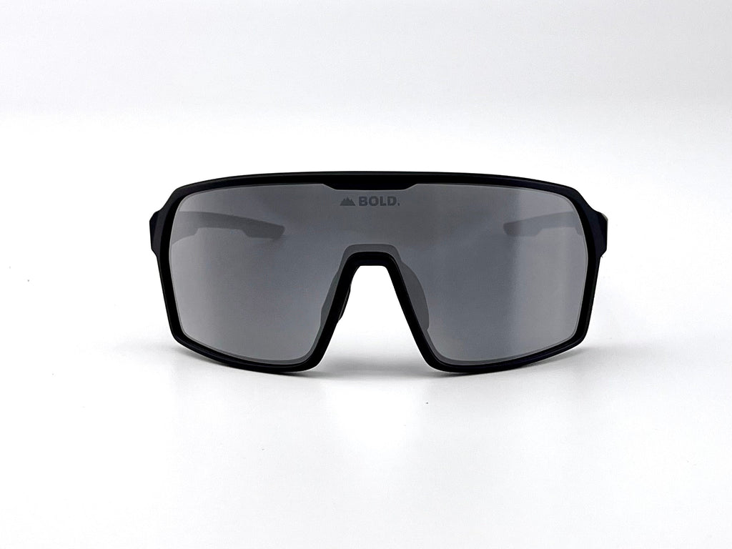 Boldouterwear Drift photochromic sunglasses showing stylish outdoor eyewear with darkened lenses in a natural outdoor setting.