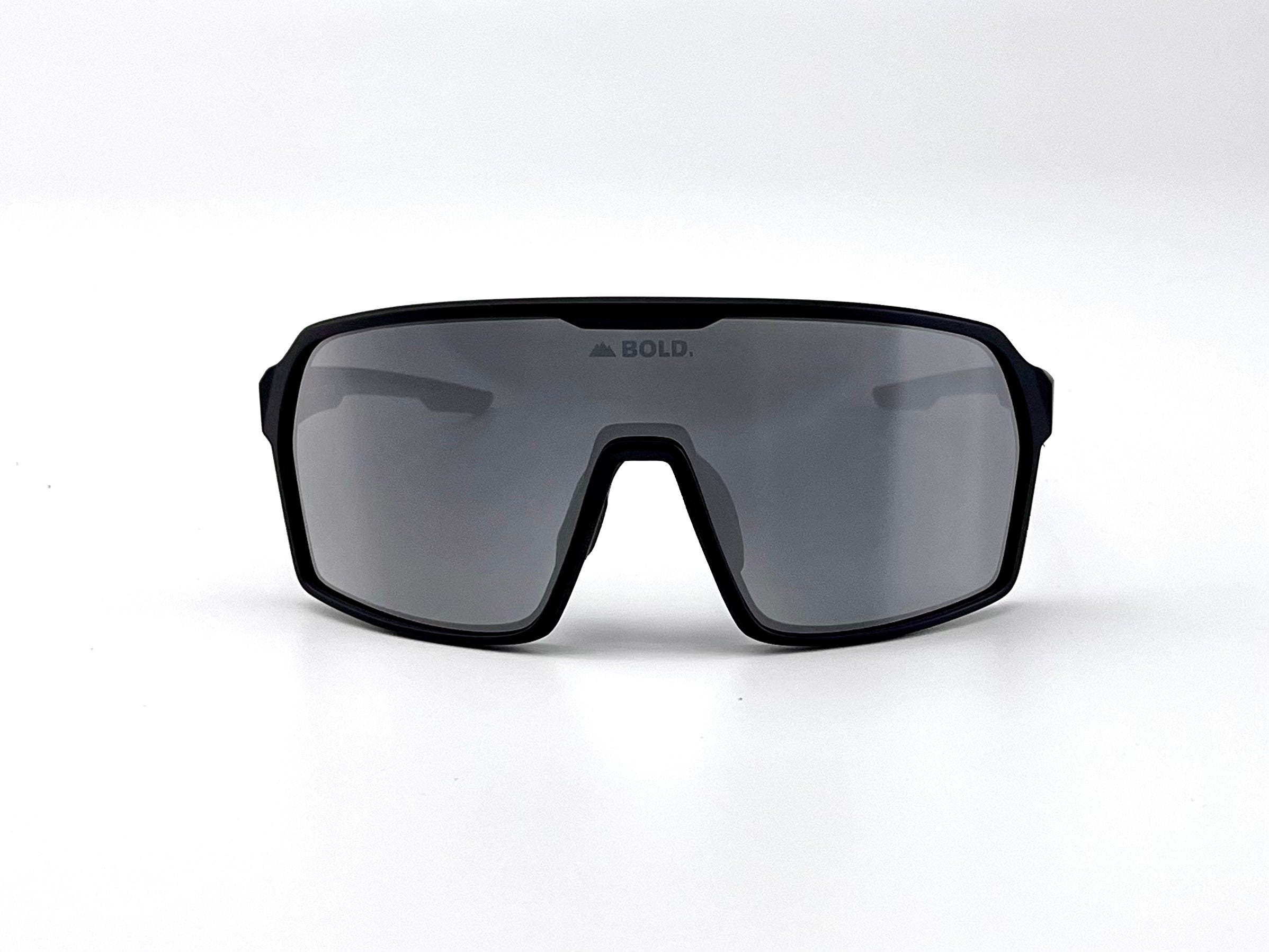 Boldouterwear Drift photochromic sunglasses showing stylish outdoor eyewear with darkened lenses in a natural outdoor setting.