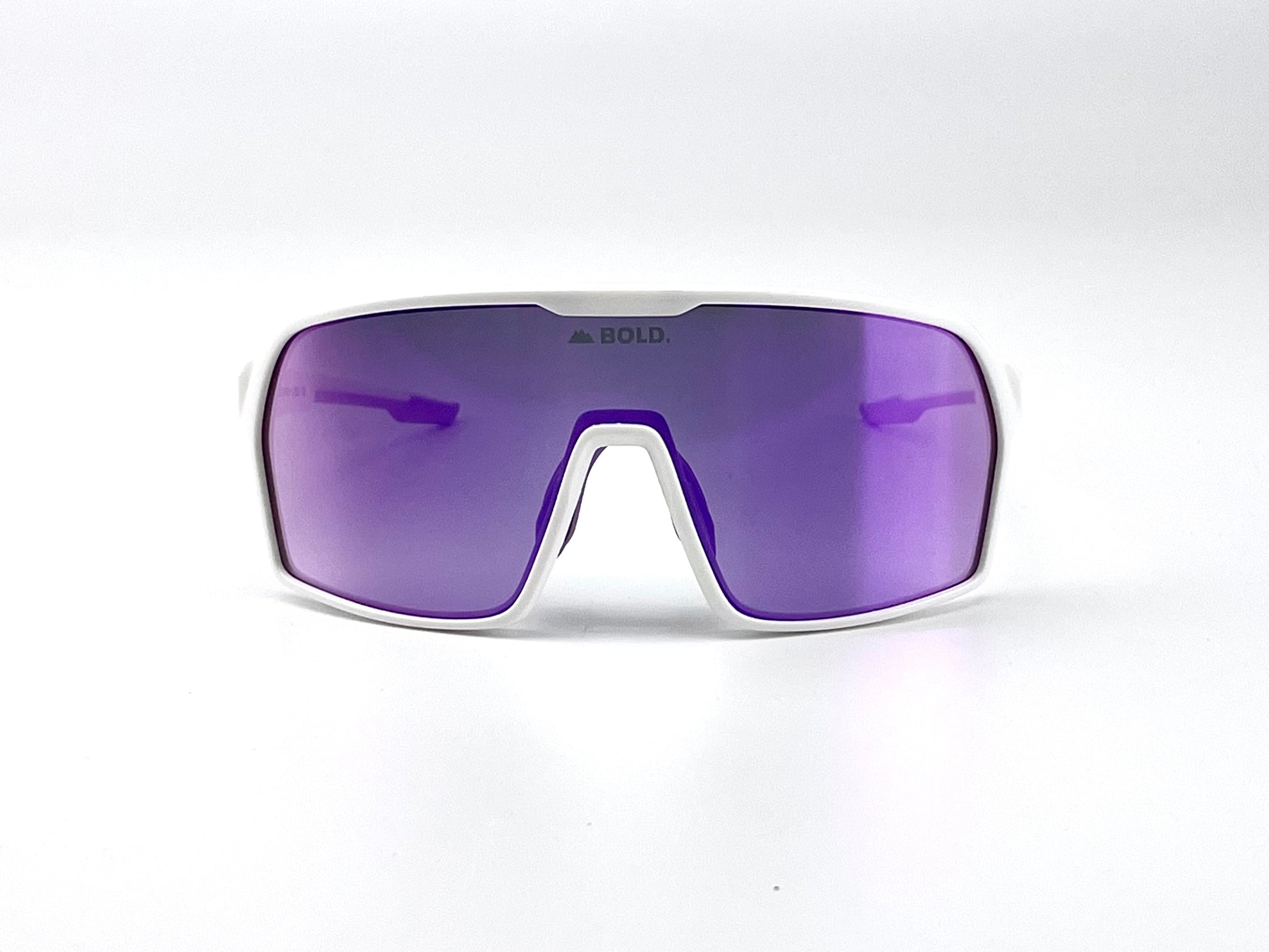 Boldouterwear BOLD Drift photochromic sunglasses outdoors, showing sleek black frame and tinted lenses in natural outdoor setting.