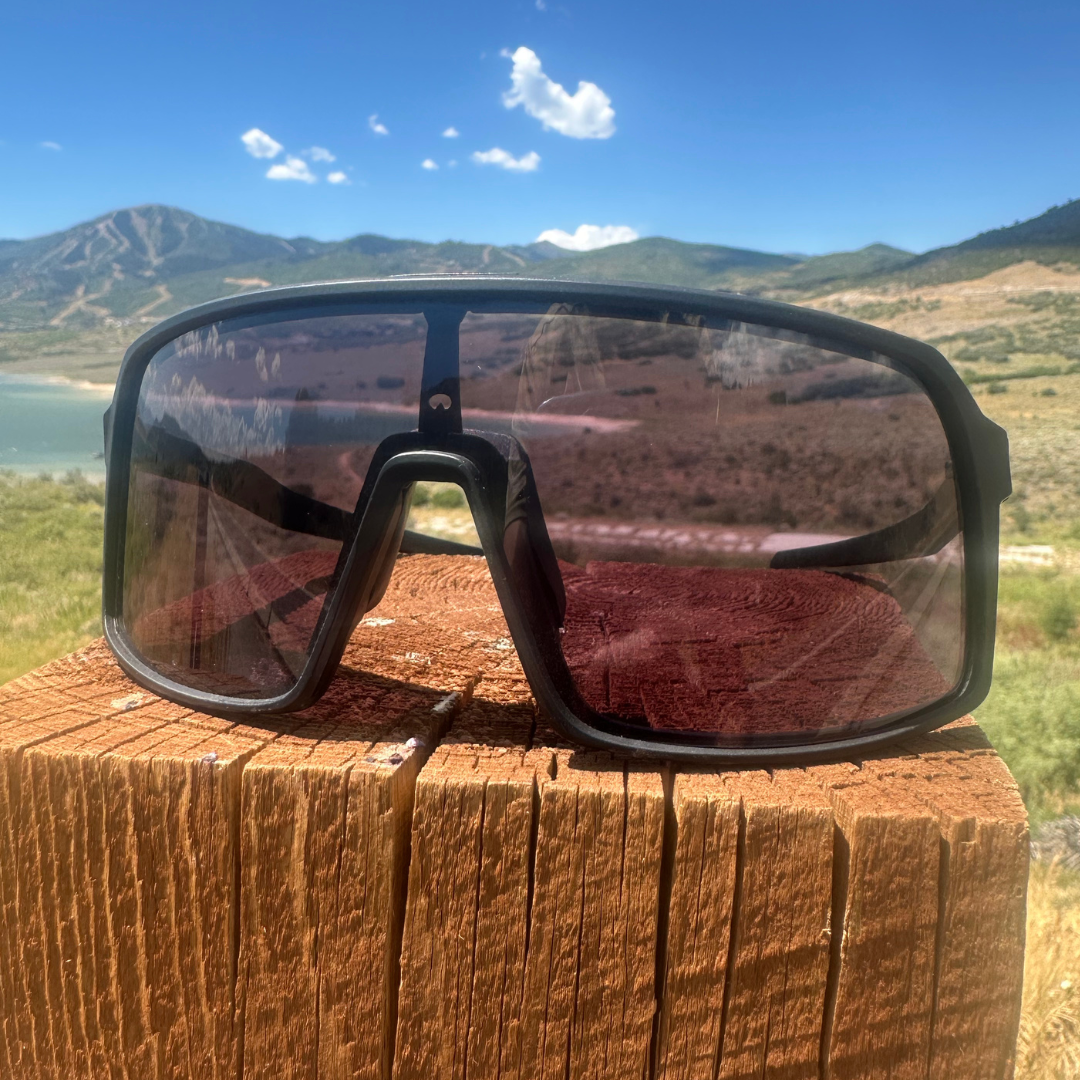 Photochromic Kamas mountain bike sunglasses by Eastern Outer, shown outdoors with reflective lenses and sporty frame design.