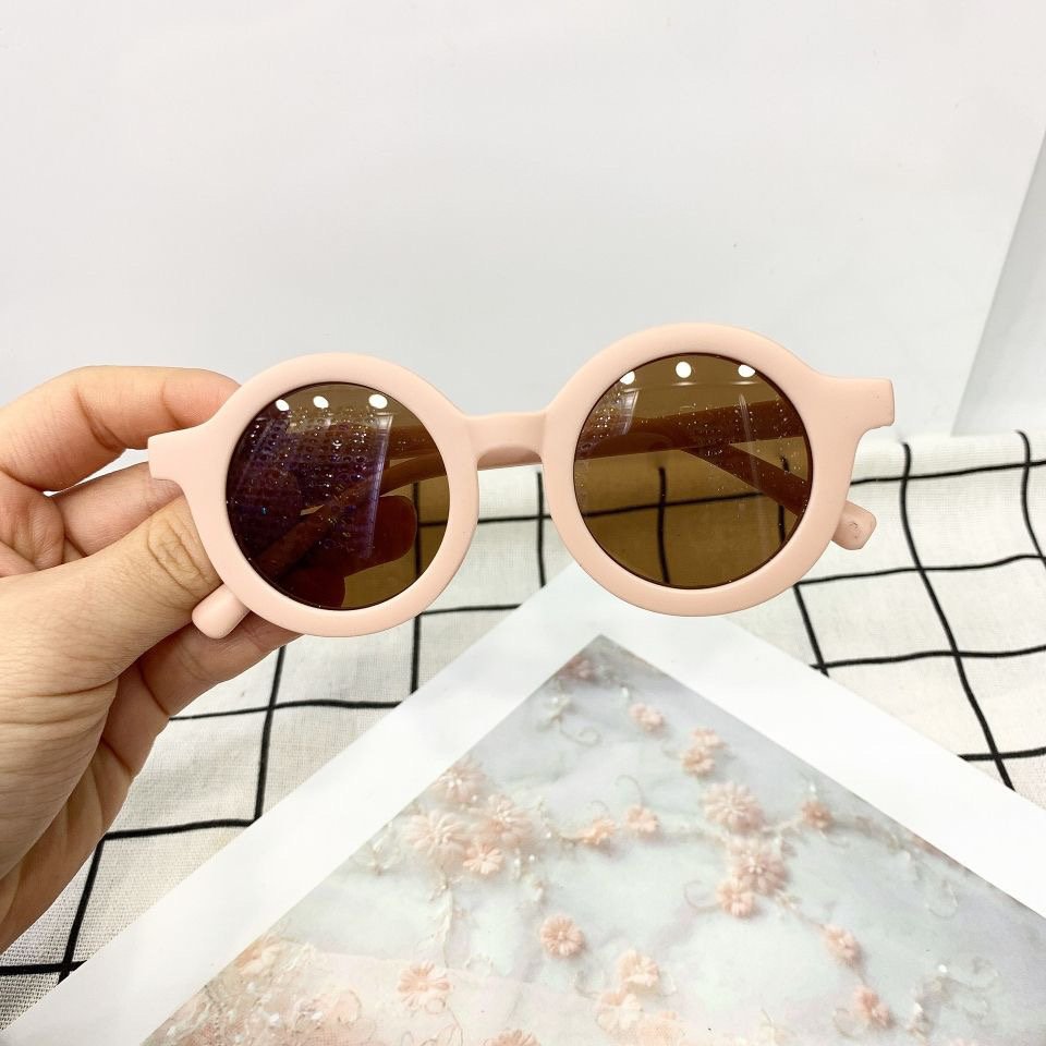 Round vintage style kids sunglasses by ozznekshoes with dark lenses and colorful frames, perfect for young fashionistas.