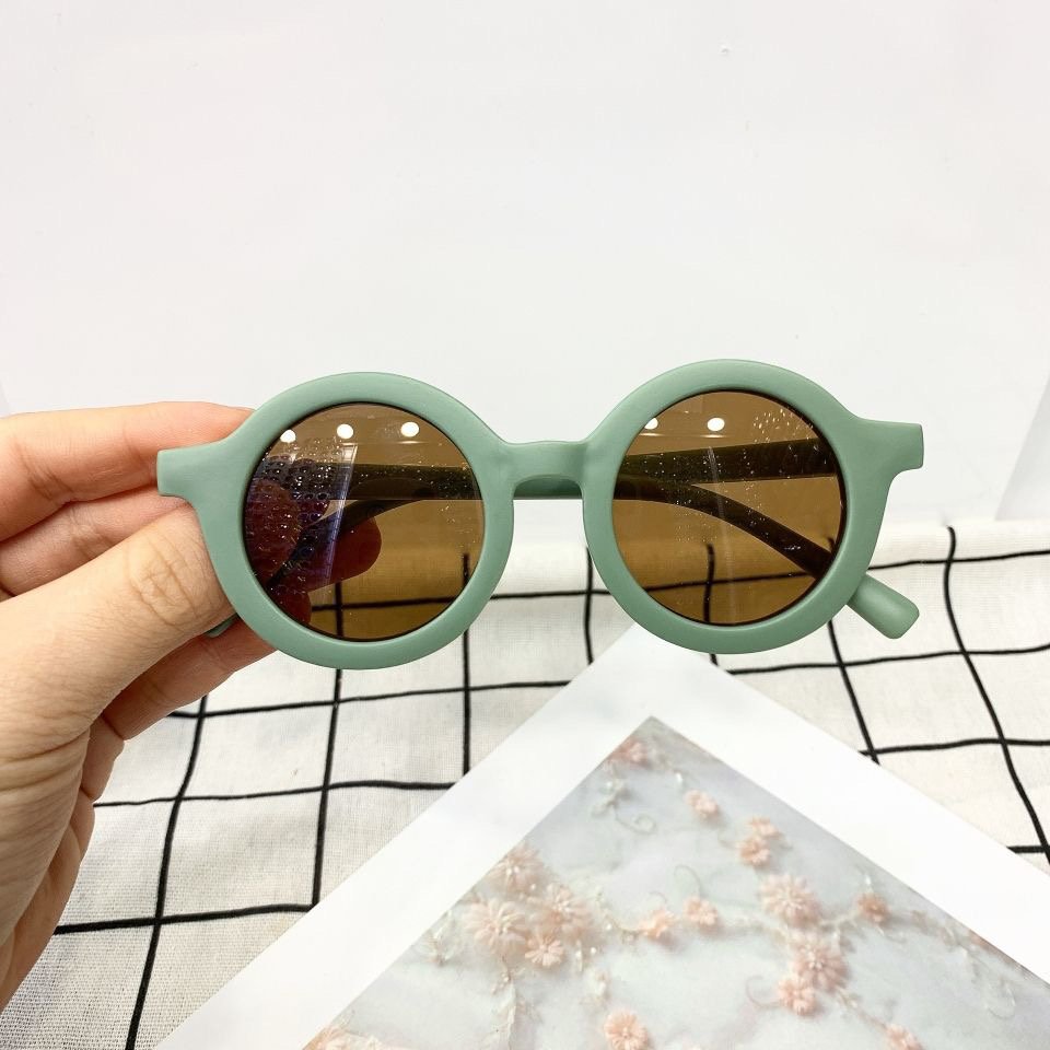 Vintage style kids sunglasses with round frames by ozznekshoes, featuring classic design and tinted lenses for children.
