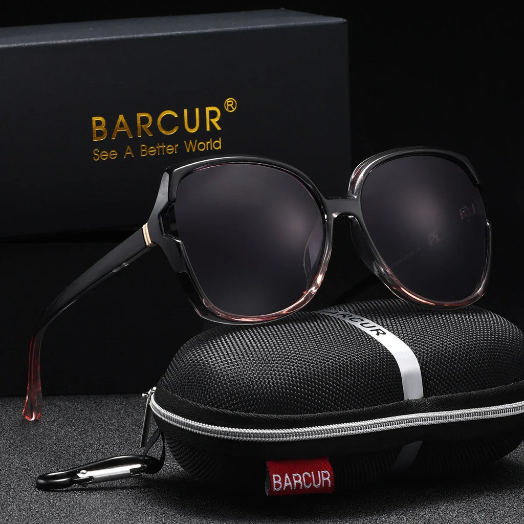 Stevvex BARCUR oversized polarized UV400 sunglasses with black frames and dark tinted lenses, reflecting sunlight outdoors.