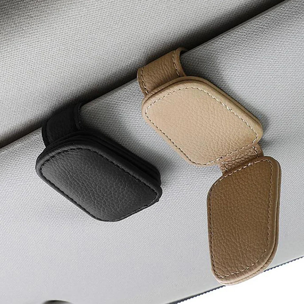 Econic Blanks universal car sun visor sunglasses clip holding sunglasses on a vehicle sun visor.