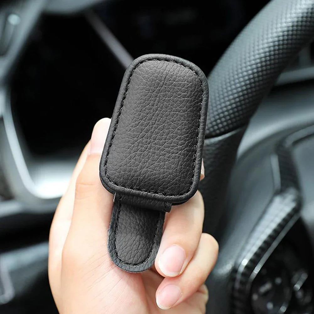 Econic Blanks universal car sun visor sunglasses clip holding sunglasses on a vehicle sun visor in a close-up shot
