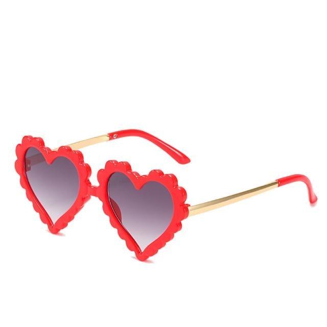Kids' heart-shaped sunglasses by Stevvex with flower design, oversized frame, stylish and UV protective for children.