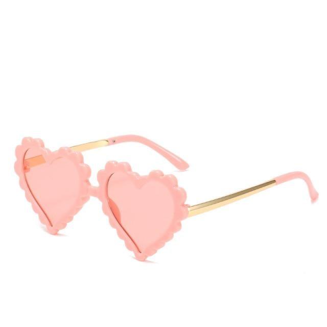 Kids' heart-shaped sunglasses by Stevvex featuring a cute, oversized design with flower and love details, UV protection for children.