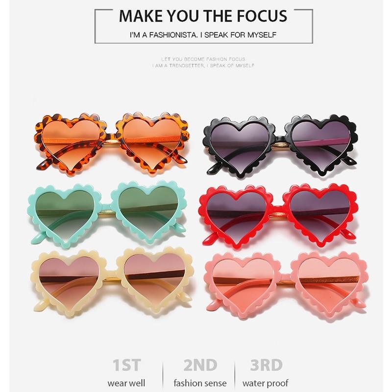 Kids' heart-shaped sunglasses by Stevvex with a playful design, oversized frames, floral accents, and UV protection.