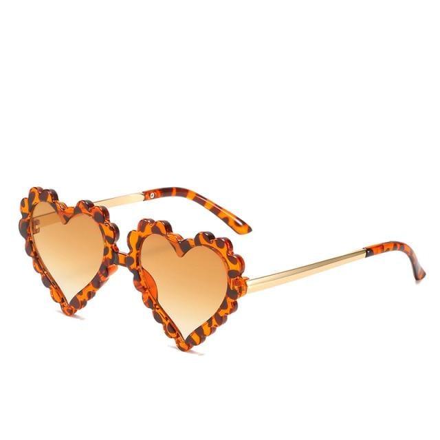 Kids' heart-shaped sunglasses by Stevvex featuring a cute, oversized design with floral accents, offering UV protection.